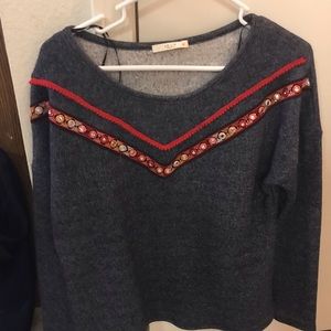 Blue sweater with red embellishments